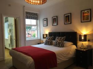 a bedroom with a bed with two pillows and a window at Holway House in Sheringham