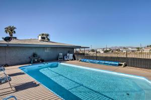 a swimming pool on a deck next to a house at 4 Mi to Beach Lake Havasu Apartment with Pool! in Lake Havasu City