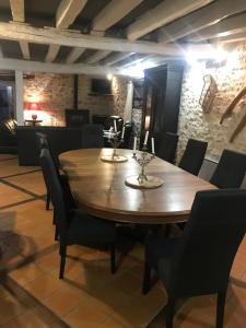 a dining room with a wooden table and chairs at Le Boursignoux in La Trimouille