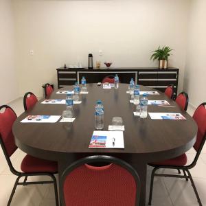 a conference room with a large table with bottles of water at LH Plaza Hotel in Chapecó