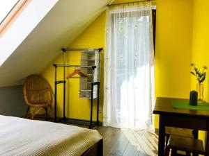 a bedroom with a bed and a window and a desk at OSADA WASYLÓWKA in Laskowa