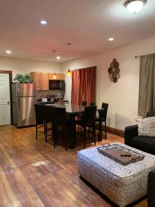 a living room and kitchen with a table and chairs at Cozy 4 Bedroom Home Accommodates 10 in Niagara USA in Niagara Falls