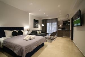 ZH Luxury Suites في سلانيك: غرفة نوم بسرير كبير وغرفة معيشة