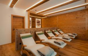 a row of chairs in a room with wooden walls at alpdeluxe-Apartments Holzgau in Holzgau