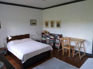 a bedroom with a bed and a table and a desk at Casa da Lomba do Cavaleiro in Povoação