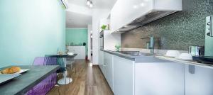 a kitchen with white cabinets and a counter top at B&B Campari 10 in Pavia