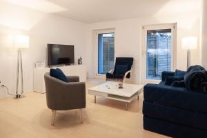 TV/trung tâm giải trí tại 2,5 Zi Design Loft Wohnung mit Gartensitzplatz