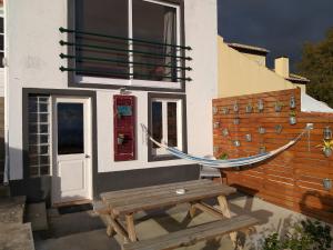 a hammock on the side of a house at Casa da Lomba do Cavaleiro in Povoação