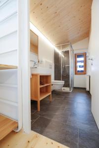 a bathroom with a tub and a sink and a toilet at Frühstückspension Sonnblick in Stuben am Arlberg +42 photos