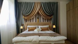 a bedroom with a large bed with curtains at Apartment 15 in Borovets +89 photos