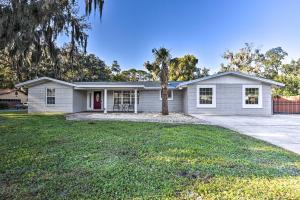 a house with a palm tree in front of it at Jacksonville Gem - Ideal Location to Beaches! in Jacksonville