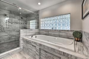 a large bathroom with a tub and a window at Jacksonville Gem - Ideal Location to Beaches! in Jacksonville +22 photos
