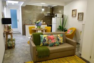 a living room with a couch and a kitchen at Salty Stories in Ponta Delgada
