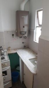 a small kitchen with a sink and a stove at Departamento 2 amb centro in Mar del Plata