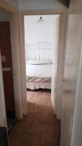 a hallway with a bed in a white room at Departamento 2 amb centro in Mar del Plata