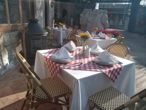 a table with plates and napkins on top at Hotel Morelia Boutique Villa Italia in Morelia