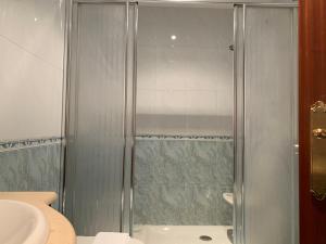 a shower with a glass door in a bathroom at Oktheway San Eufrasio in Sarria