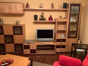 a living room with a television on a wooden entertainment center at Oktheway San Eufrasio in Sarria