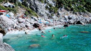 a group of people swimming in the river at Emidio House in Termini