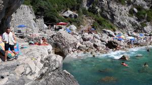 a group of people in the water at a beach at Emidio House in Termini