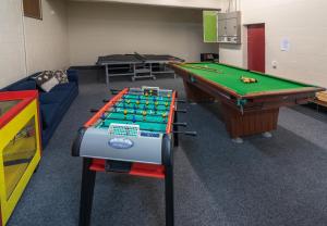 a room with a pool table and a couch at Skotel Alpine Resort in Whakapapa Village