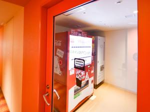 a hallway with orange walls and a door at Hotel Universal Port Vita in Osaka