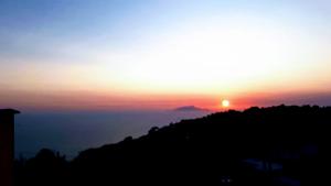 a sunset on top of a mountain with the sun setting at Emidio House in Termini