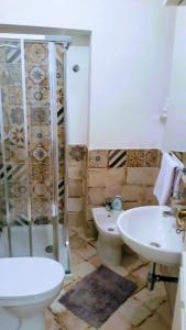 a bathroom with a shower and a toilet and a sink at Emidio House in Termini