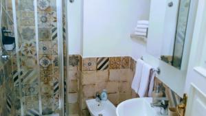 a bathroom with a sink and a shower at Emidio House in Termini