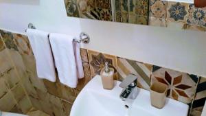 a bathroom with a white sink and a mirror at Emidio House in Termini
