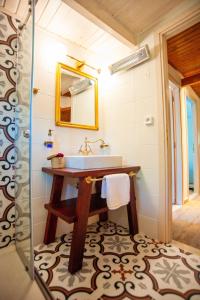 a bathroom with a sink and a shower at Villa Spitaki in Nikiana