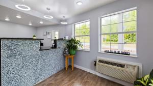 a kitchen with a counter and windows in a room at Apple Valley Inn Pigeon Forge in Pigeon Forge