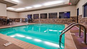 a swimming pool with blue water in a hotel at SureStay Plus Hotel by Best Western Coffeyville in Coffeyville