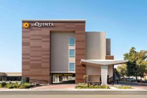 a building with a sign on the front of it at La Quinta by Wyndham Clovis CA in Clovis