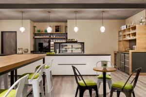 a kitchen that has a table and chairs in it at Super 8 by Wyndham Hamburg Mitte in Hamburg