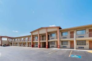 an exterior view of an apartment building with a parking lot at Super 8 by Wyndham Waco/Mall area TX in Waco