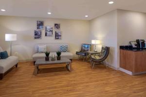 a living room with a couch and a table at WoodSpring Suites Frederick I-70 in Frederick