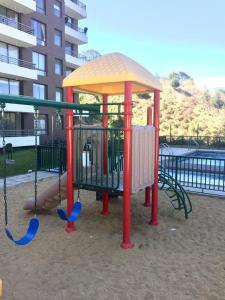 a playground with a swing set in front of a building at Parque Mirador II - 3 Dormitorios - Excelente vista in Viña del Mar +21 photos