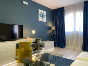 a living room with a yellow chair and a television at Los Bronces in Lucena