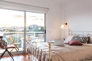 a bedroom with a bed with a laptop on it at Pátio da Achada View Apartment in Funchal