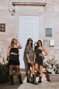 three girls are standing in front of a door at Port'Amare in Bari