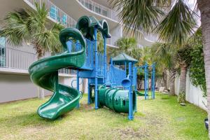 a playground with a slide in front of a building at Caribe Resort in Orange Beach