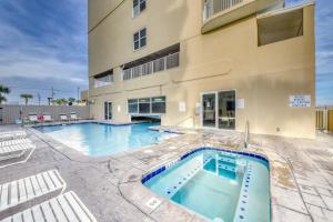 a swimming pool in front of a building at Island Royale in Gulf Shores