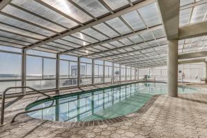 una piscina cubierta con un gran edificio con ventanas en The Colonnades en Gulf Shores
