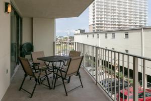 a patio with a table and chairs on a balcony at Gulf Village #215 in Gulf Shores