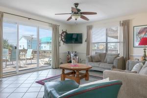 a living room with a couch and a table at Heron Landing in Gulf Shores