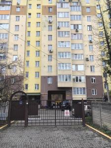 a large building with a gate in front of it at Great apartment in the city centre in Ivano-Frankivsʼk