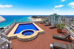 a balcony with a swimming pool on top of a building at ULTIQA Points North in Gold Coast +144 photos