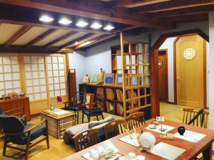 a living room with a table and chairs and a library at BluePlanet in Gyeongju