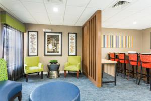 a waiting room with chairs and a table at Holiday Inn Express - Plymouth, an IHG Hotel in Plymouth